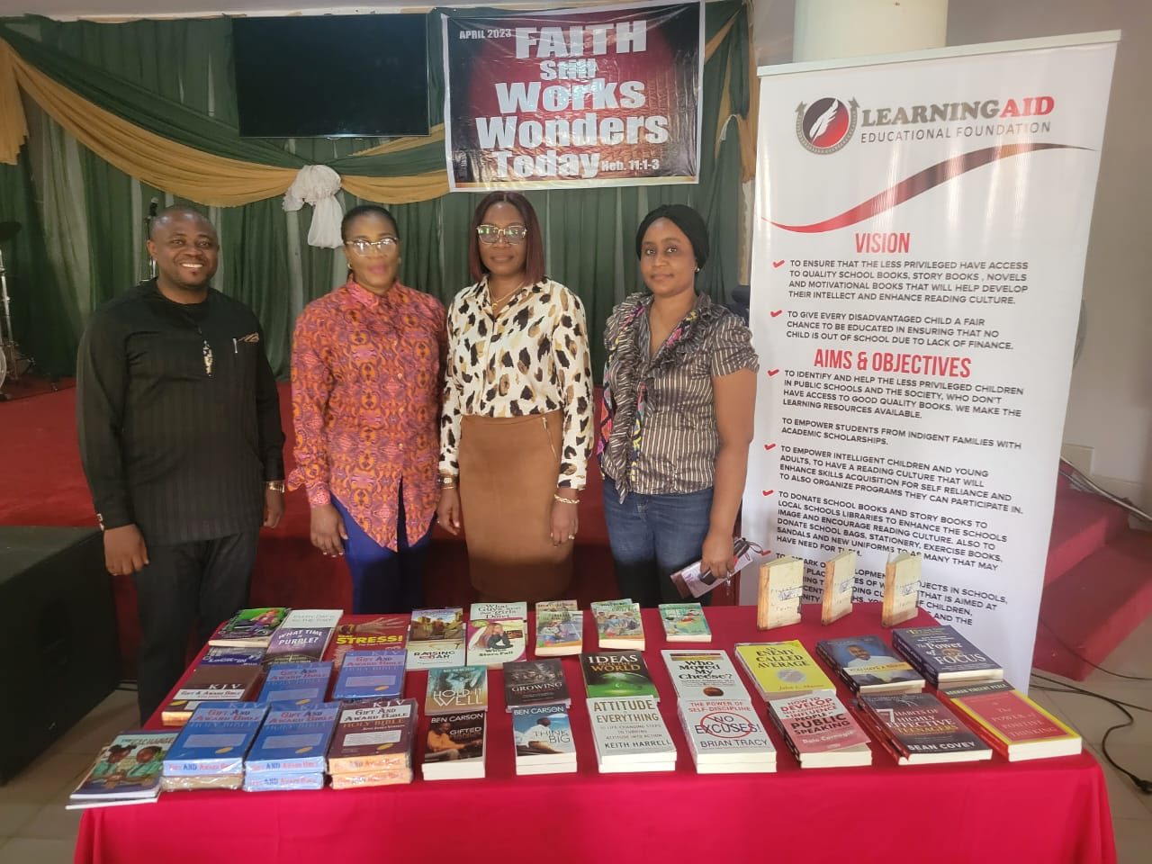 Books laid out for a donation at a teens church, with the LEF banner.