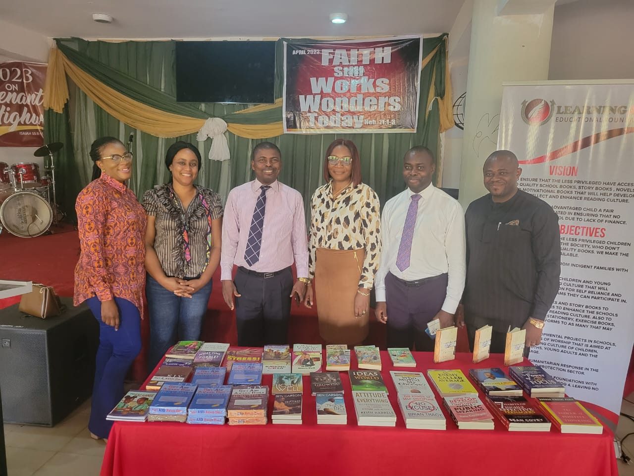 The LEF team with a table of donated books at a teens church.
