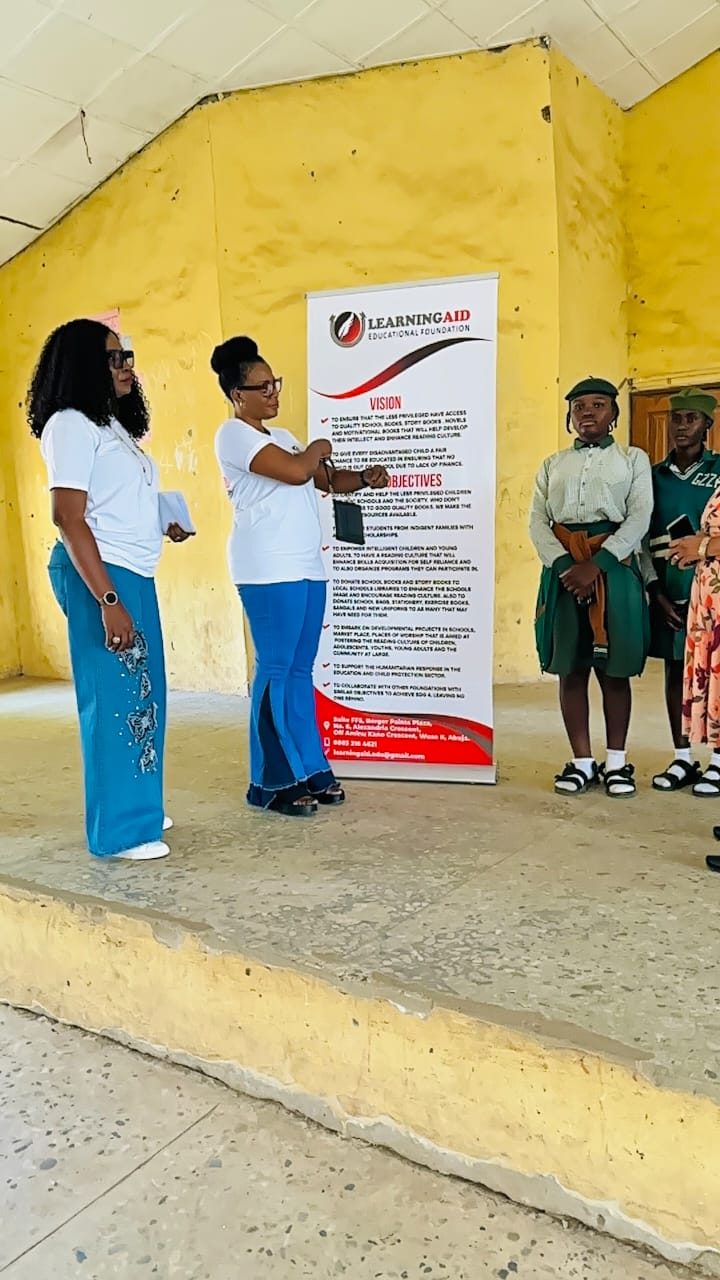 LEF handing WAEC support to an SS3 student in school uniform.